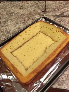 a cake sitting on top of a pan covered in tin foil