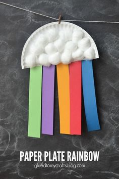 a paper plate that has been made to look like a cloud with rainbows on it