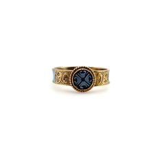 This is part of Chairish’s Fine Jewelry assortment.  This delicate and dear 14k gold ring combines some of the most enticing qualities of Victorian mourning jewellery. In its centre is a banded agate disc carved with a quatrefoil design. The agate contains two shades of blue that create an intricate X-shaped floral graphic symbol. A circular ball motif of 14k gold frames the disc, and on either side is a hand-engraved scrolling foliate of leaves. The bottom of the band features a vibrant turquoi Luxury Turquoise 14k Gold Ring, Yellow Gold Enamel Cabochon Ring, Yellow Gold Cabochon Enamel Ring, Yellow Gold Round Cabochon Enamel Ring, Yellow Gold Enamel Ring With Cabochon, Heirloom Enamel Engraved Rings, Antique Turquoise Ring In Yellow Gold, 14k Gold Cabochon Round Band Jewelry, 14k Gold Round Band Cabochon Jewelry