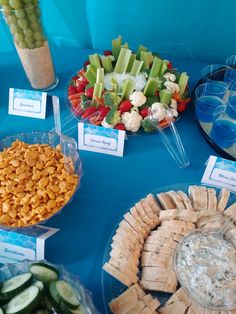 a table topped with lots of different types of food and snacks on top of it