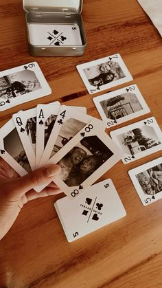 a person is playing cards on a table