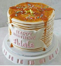 a birthday cake with frosting and sprinkles sitting on top of a plate