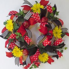 a wreath with sunflowers and apples on it