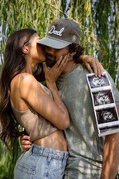 a man and woman kissing each other in front of a tree with an x - ray