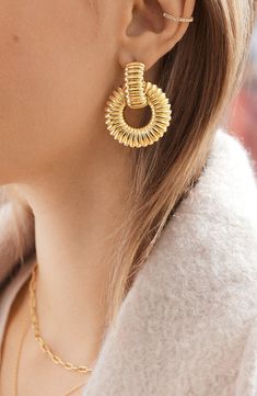 These textured frontal hoop earrings are finished in goldtone plate and add a modern polish to both day and night looks. 1 1/2" drop; 1 1/4" width Goldtone plate Imported Marigold Earrings, Hoop Drop Earrings, Bold Earrings, Affordable Jewelry, Hailey Bieber, Night Looks, Day And Night, Gold Hoop, Gold Hoop Earrings