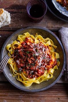 a plate of pasta with meat sauce and bread