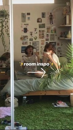 two women sitting on a bed in a room with green carpeted floors and walls