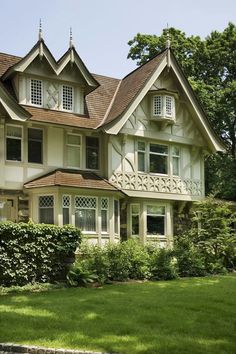 a large white house sitting on top of a lush green field