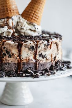 an ice cream cake with two cones on top