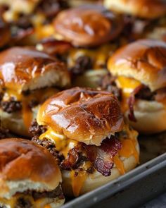 several cheeseburger sliders on a tray ready to be eaten