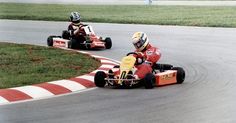 two go kart racers racing around a track