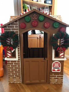 a gingerbread house made out of cardboard and decorated for christmas