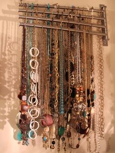 a bunch of necklaces hanging on a wall