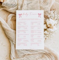 a baby's first year checklist is laid out on a table with flowers