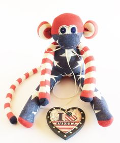 a stuffed monkey with an i love america heart