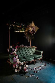 an old couch with flowers on the floor