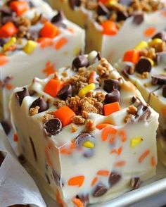 candy bars with white frosting and candies on top are sitting on a tray