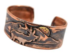 PRICES MAY VARY. Durable unisex cuff bracelet is crafted using reclaimed pure copper 1-inch-wide cuff is enhanced with an elk and mountain motif Rustic patina highlights the elk design and emphasizes the organic characteristic of copper Available in adjustable medium and large sizes (see description below for sizing detail) Artisan-crafted in the USA Adorned with an elk and mountain design, this copper cuff bracelet is individually handcrafted using rustic reclaimed copper. The cuff is provided Copper Uses, Artisan Jewelry Handmade, Cuff Bracelets Handmade, Copper Cuff Bracelet, Cuff Jewelry, Copper Cuff, Mountain Designs, Rustic Jewelry, Native Jewelry