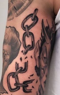 a man's arm with chains and skulls on it