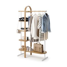 a wooden rack with clothes and handbags hanging from it's sides, on a white background