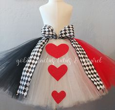 a tutu skirt with hearts and checkered ribbon on the bottom, attached to a mannequin headband