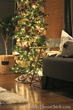 a living room with a christmas tree in the corner and other decorations on the floor