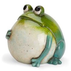 a ceramic frog sitting on top of a white surface