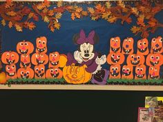 a bulletin board with mickey mouse and pumpkins