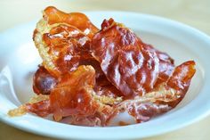 a white plate topped with pieces of bacon