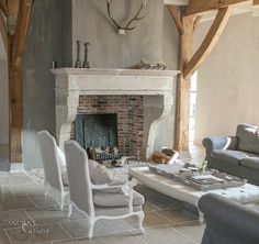 a living room filled with furniture and a fire place