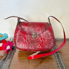 MADE IN MEXICO By: Mexican Artisans For: Women Color: red Dimensions: 9.5 x 8 x 2.5 Details: 100% Authentic Leather Style: Crossbody | Shoulder Bag Embossed Design Hook lock closure Adjustable & Non-Removable Strap: 22" Drop Contact us for more detailsPLEASE READ BEFORE PURCHASE: The picture is an ACCURATE REPRESENTATION.Colors in the pictures may vary a little by effects of light. Each product is handmade from Mexico causing differentiation and minor imperfections in each piece making them that Red Rectangular Flap Bag With Mobile Phone Holder, Red Rectangular Flap Bag For Mobile Phone, Red Flap Bag For Daily Use, Red Flap Bag With Mobile Phone Pocket For Travel, Red Flap Bag With Mobile Phone Bag For Travel, Red Flap Bag With Mobile Phone Holder For Travel, Red Satchel Flap Bag With Mobile Phone Holder, Red Satchel Shoulder Bag With Mobile Phone Pocket, Red Crossbody Mobile Phone Bag