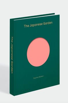 the japanese garden book is green and has pink circle on it's front cover