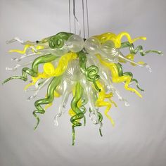 a yellow and green glass chandelier hanging from a ceiling