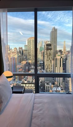 a bedroom with a view of the city