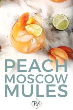 peach moscow mules with lime and orange slices on the rim, garnished with fresh fruit