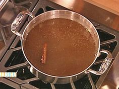 a pot on top of an oven filled with liquid