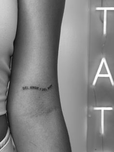 a woman's lower arm with the word del monte on it, in black and white