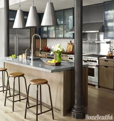 a kitchen with an island and bar stools