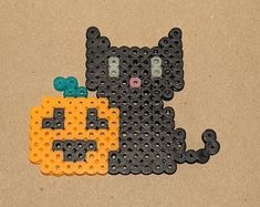 a black cat and orange pumpkin made out of legos