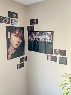 a room with pictures on the wall and a potted plant