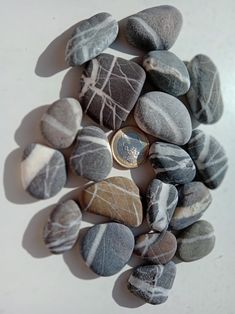 some rocks and a coin on a white surface