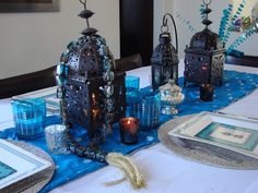 the table is set with blue and silver decorations