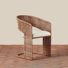 a wicker chair sitting on top of a brick floor