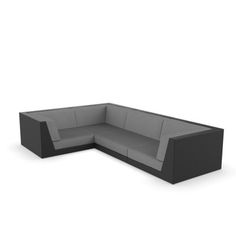 a black and grey sectional couch sitting on top of a white floor