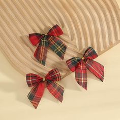 three red and green plaid bow clips