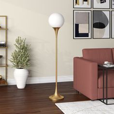 a living room scene with focus on the floor lamp and pink couch in the foreground