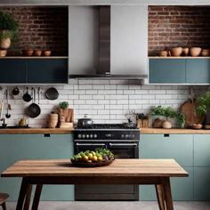 Modern kitchen with brick backsplash, stainless steel stove, green cabinets, hanging utensils, and a wooden table with a bowl of lemons. Colorful Kitchen Backsplash, Backsplash Inspiration, Boho Chic Kitchen, Kitchen Backsplash Inspiration