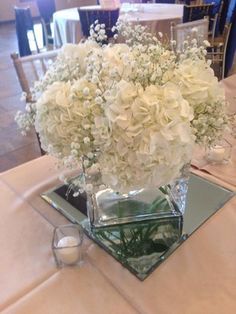 a vase filled with white flowers on top of a table