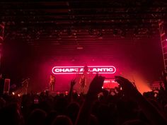 a group of people standing on top of a stage with their hands in the air