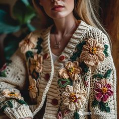 a woman wearing a sweater with flowers on it